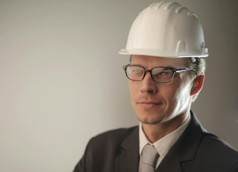 Confident engineer in suit and hard hat, ready for construction project.